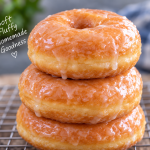 Homemade yeast raised donuts cooling on a rack